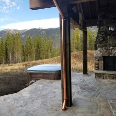 Custom copper downspout on deck/patio