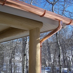 Copper half-round gutter and round downspouts