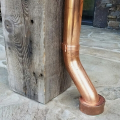 Custom copper downspout on deck/patio